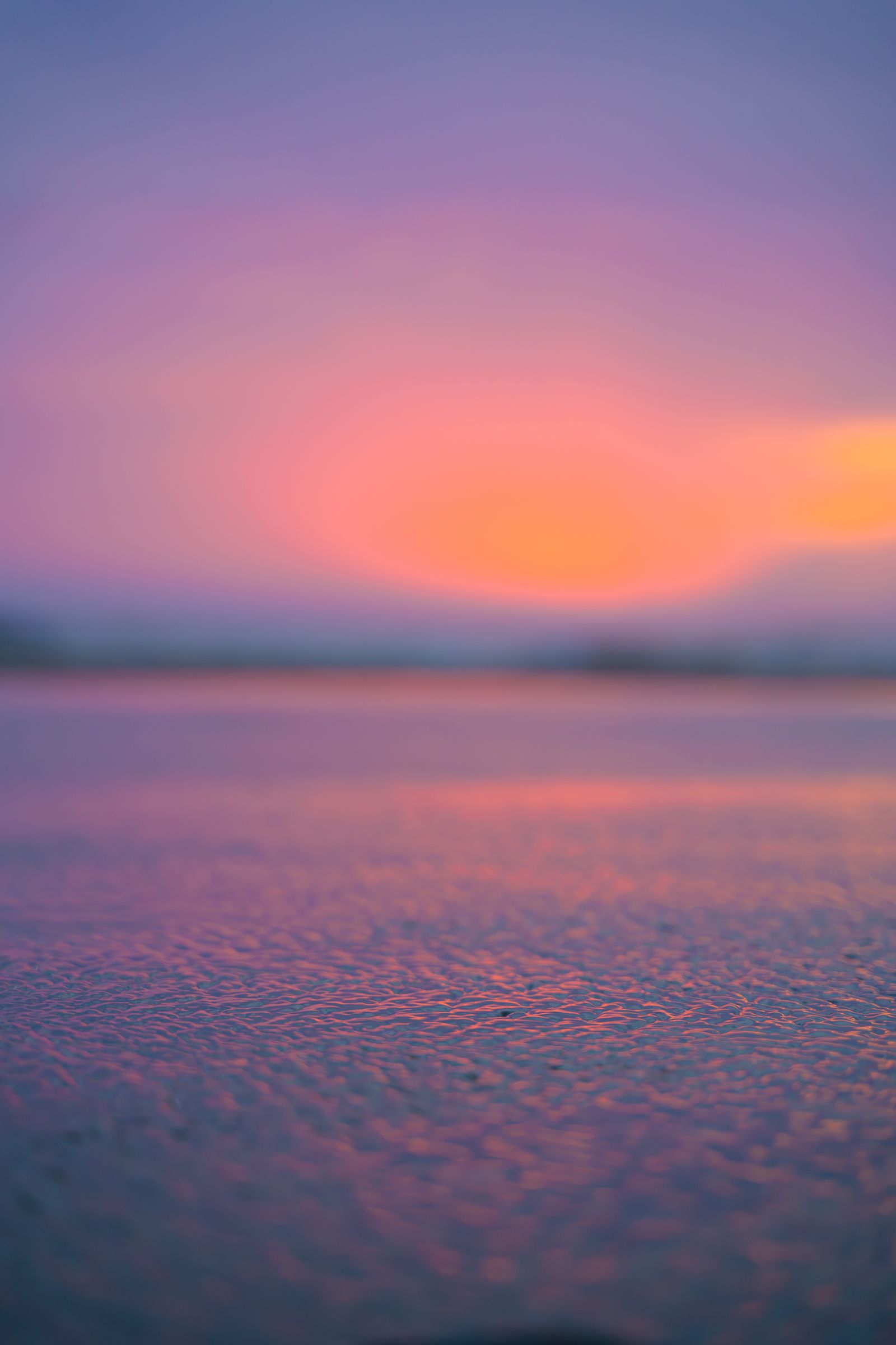 A vibrant sunset reflecting on calm ocean waves
