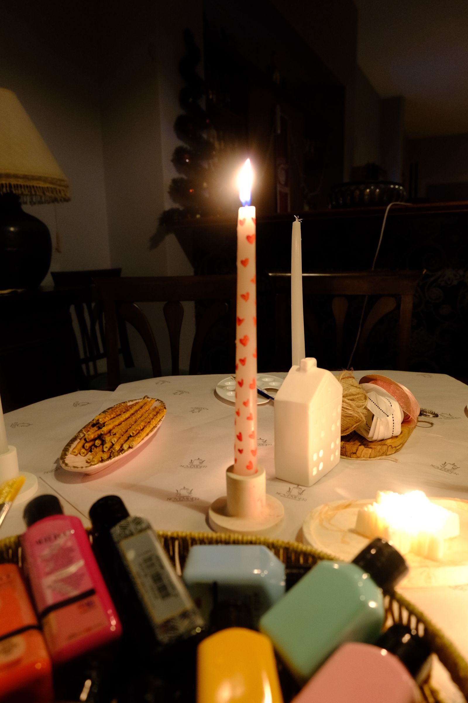 A candlelit reception scene with warm textiles and soft decor
