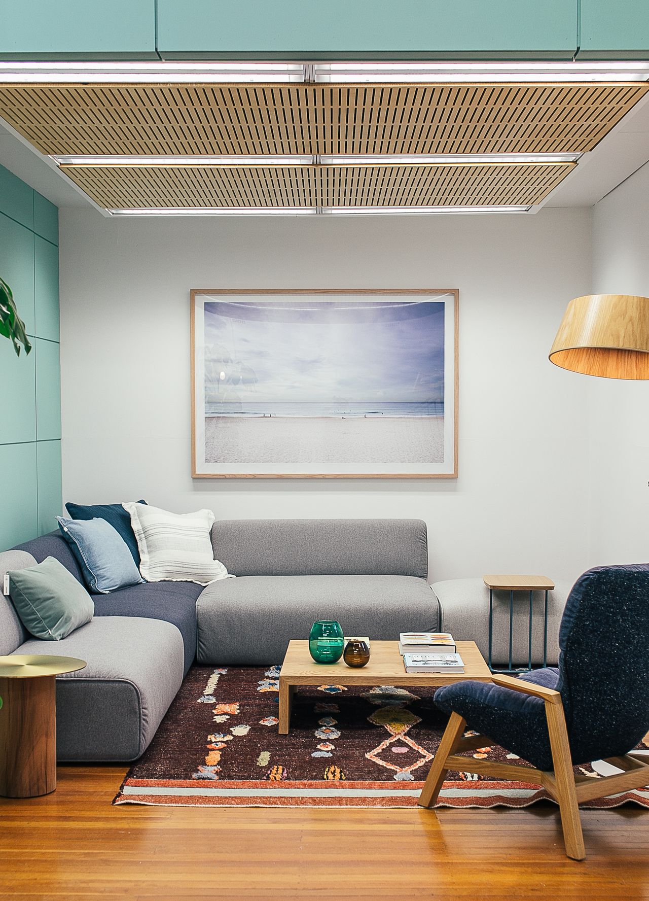 The Harbour Suite: a bright sitting area with a deep sofa, armchair, and warm wooden details