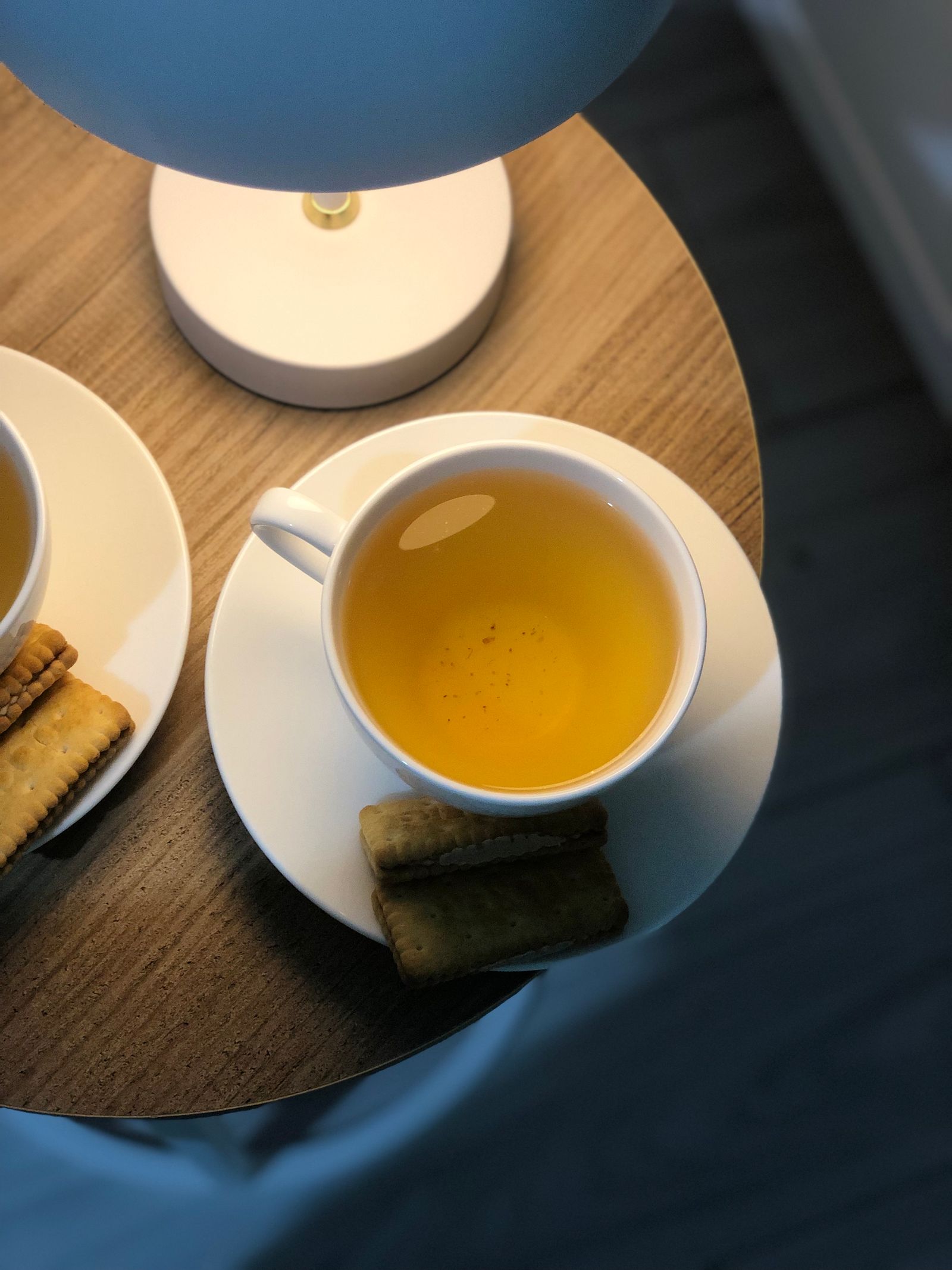 A styled welcome table with tea and biscuits on warm wood