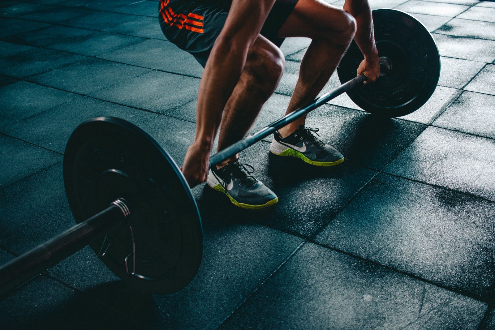 Close-up of chalked hands gripping a loaded barbell before a lift