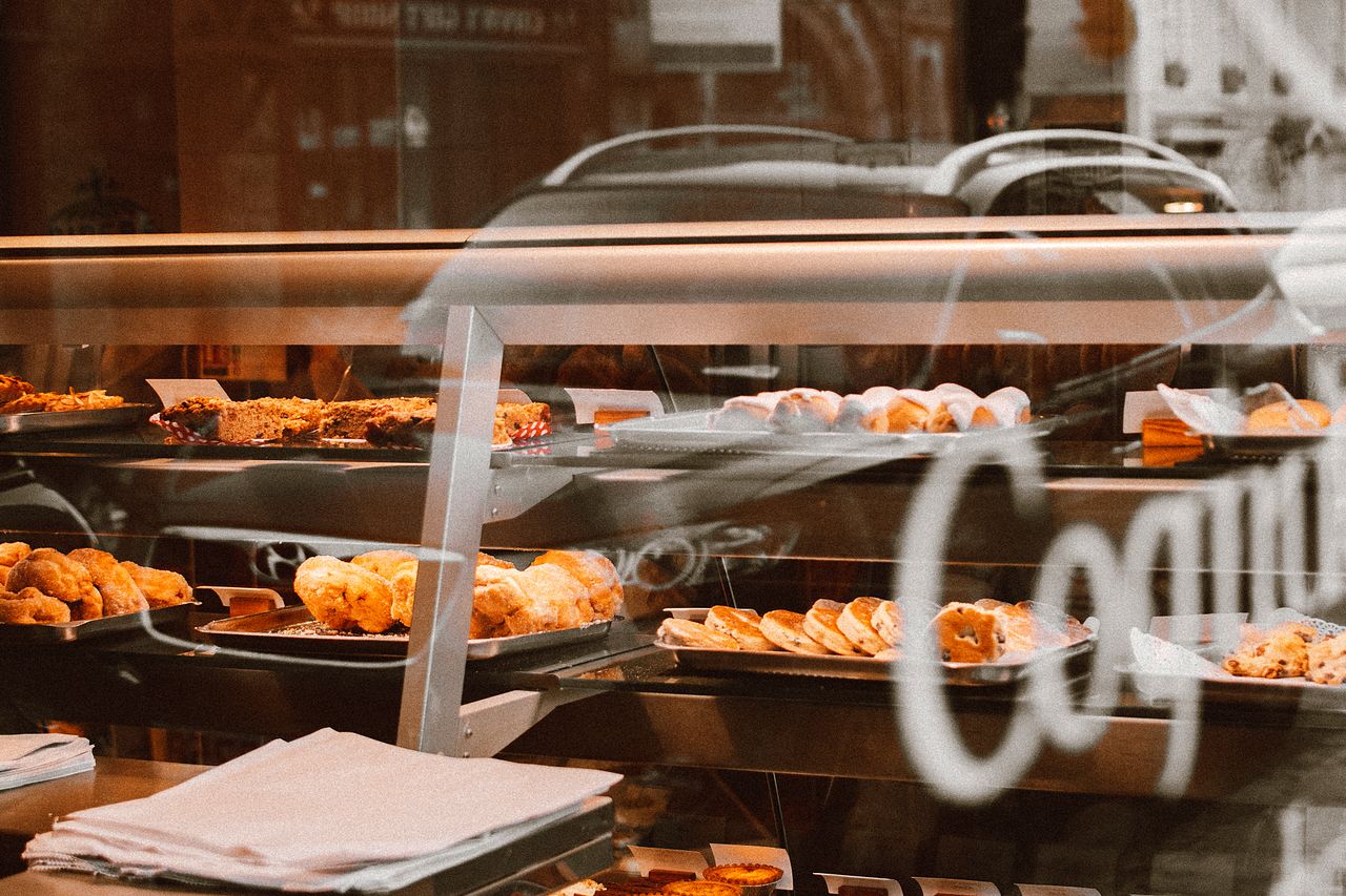 Rows of freshly baked golden loaves of bread lined up in a bakery