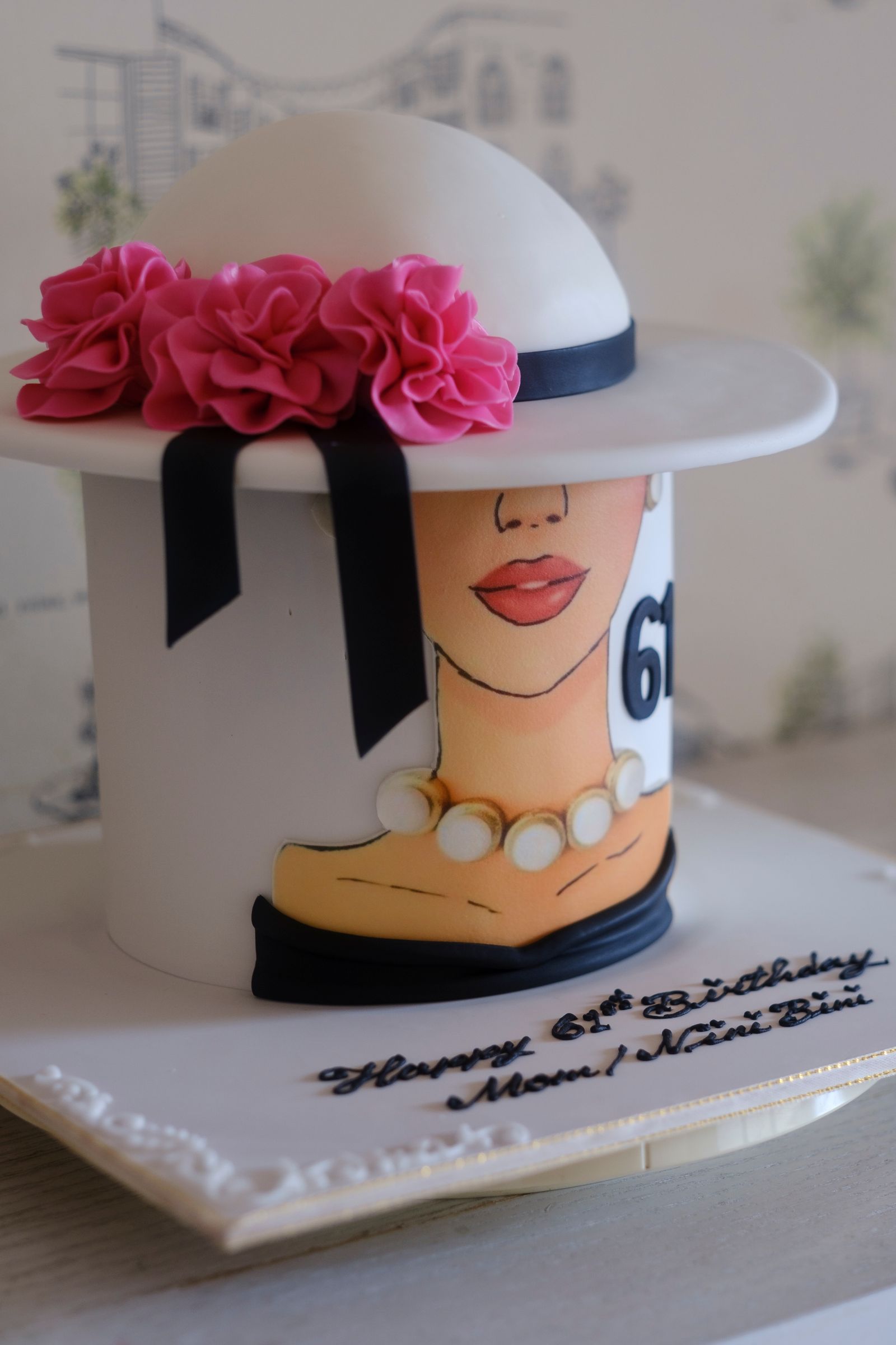 An elegant celebration cake decorated by hand with delicate floral accents