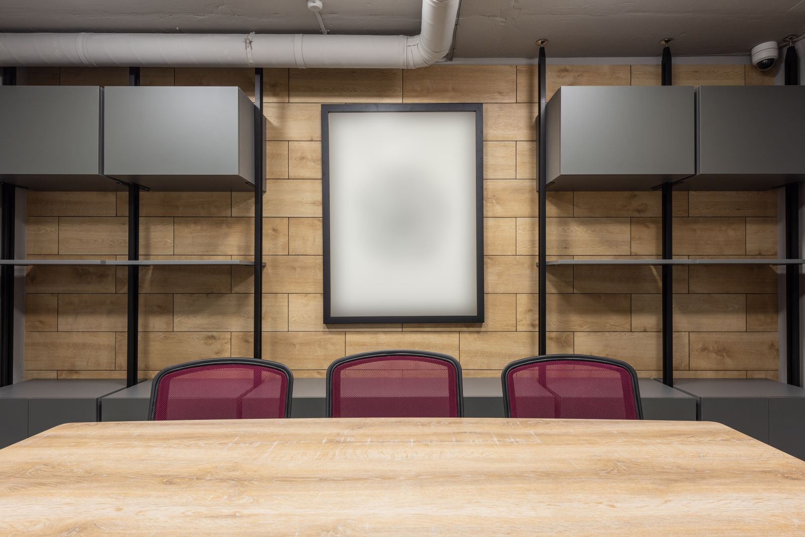 Contemporary boardroom with warm wood paneling and modern furniture