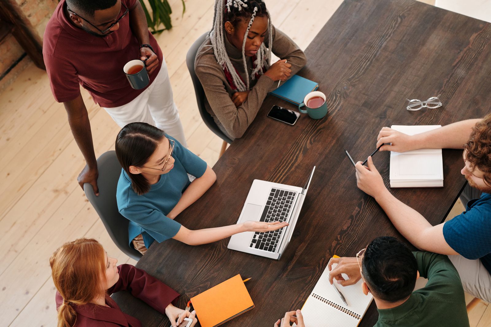 Colleagues seated around a conference table in a bookable meeting room