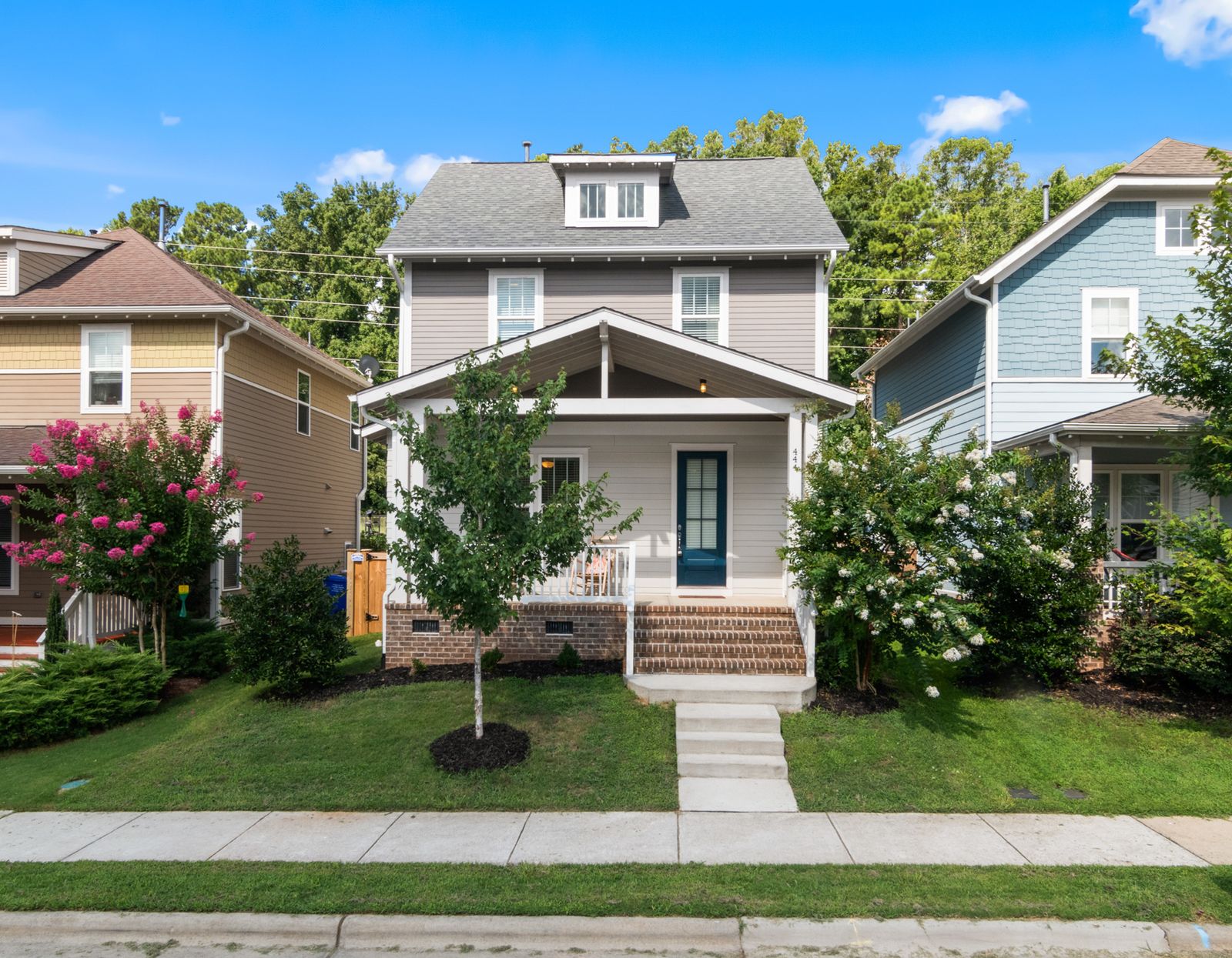 Exterior of a well-maintained suburban house with a landscaped front yard