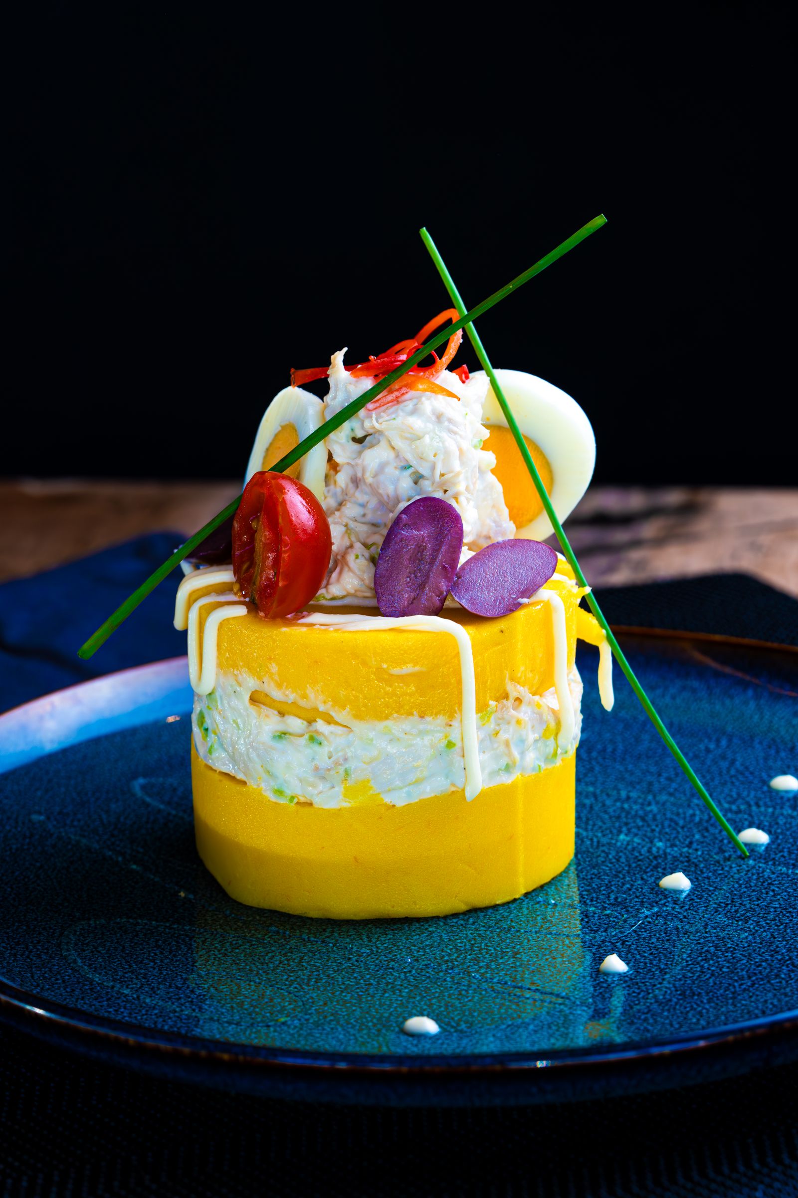 A gourmet dish of vegetables and garnish plated by a chef