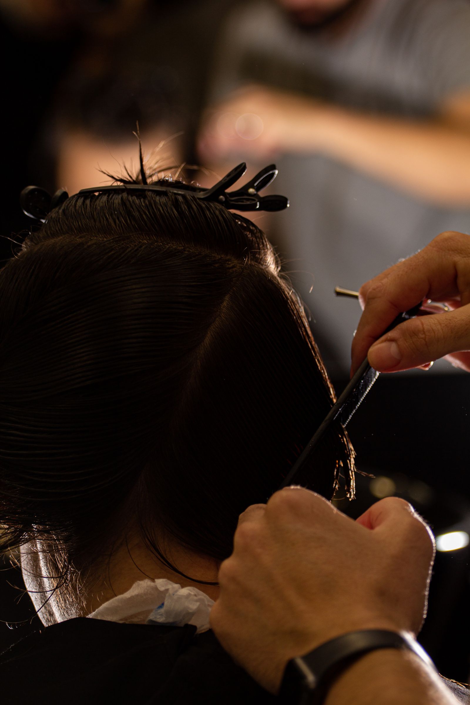 Close-up of a barber's scissors precisely cutting a client's hair