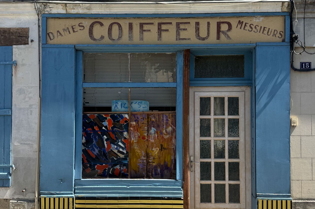 Vintage-style barbershop storefront with classic signage and facade