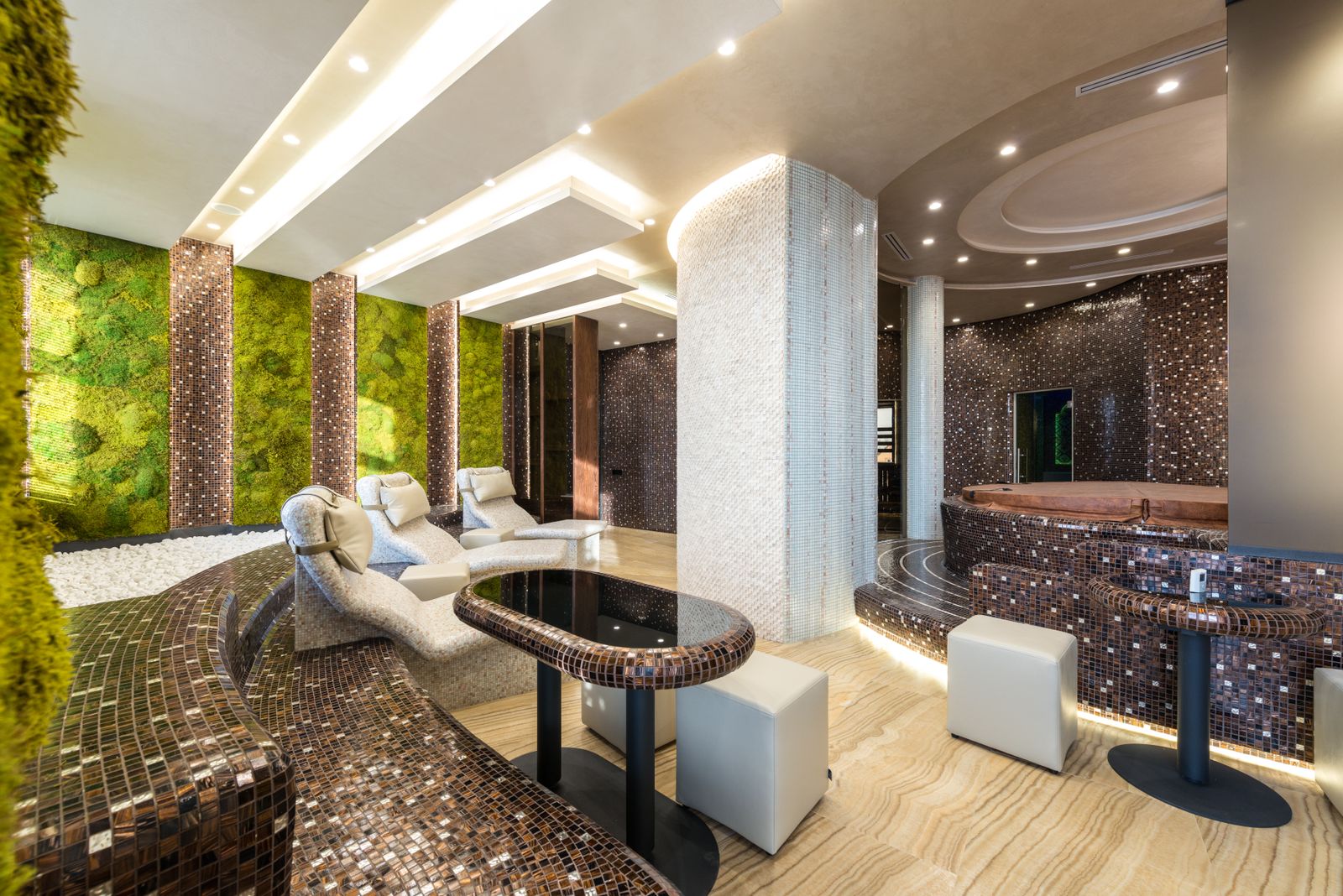 The studio: a modern, calm spa interior with loungers and soft natural light