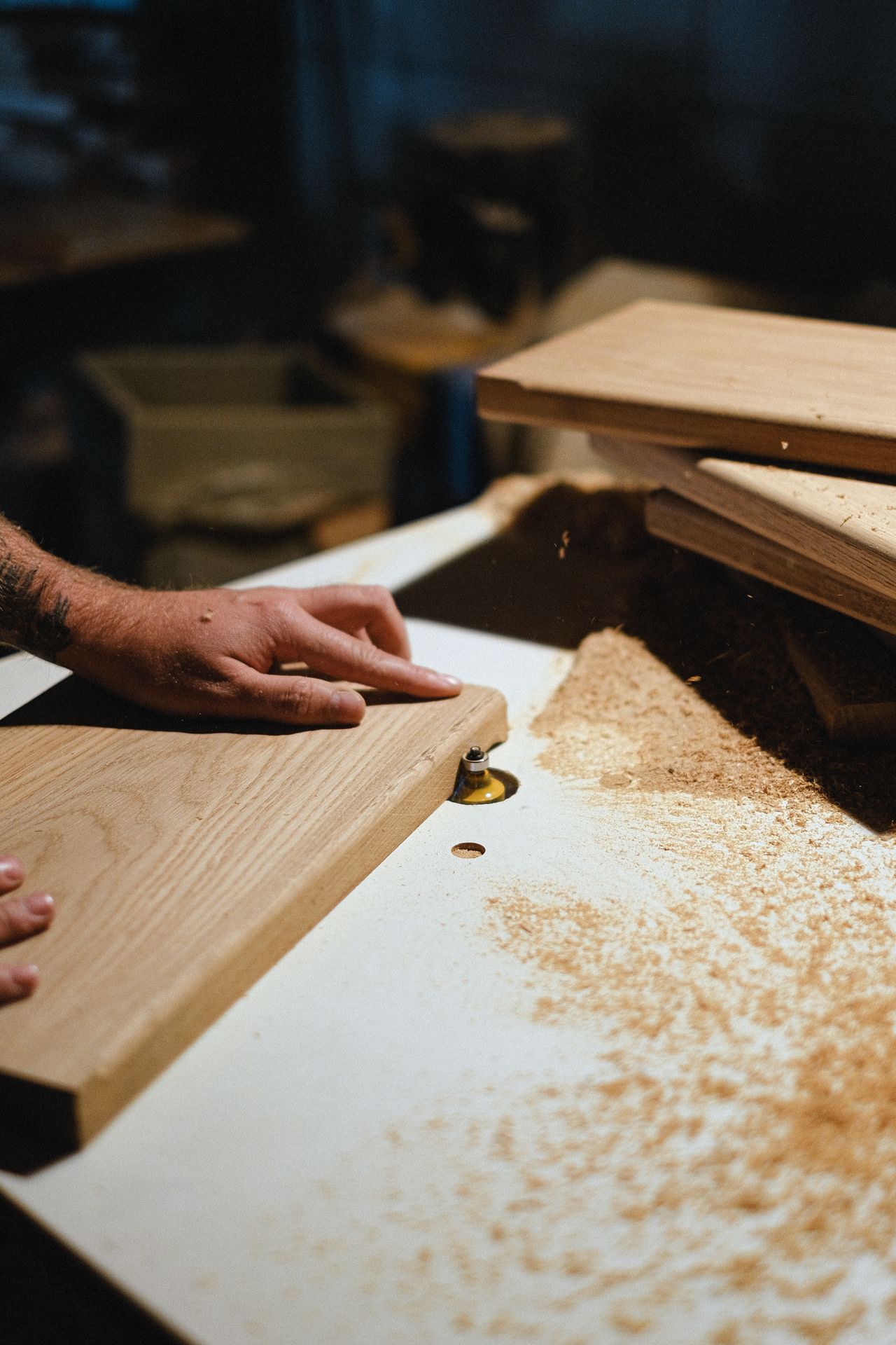 A carpenter shaping a wood plank by hand in the workshop