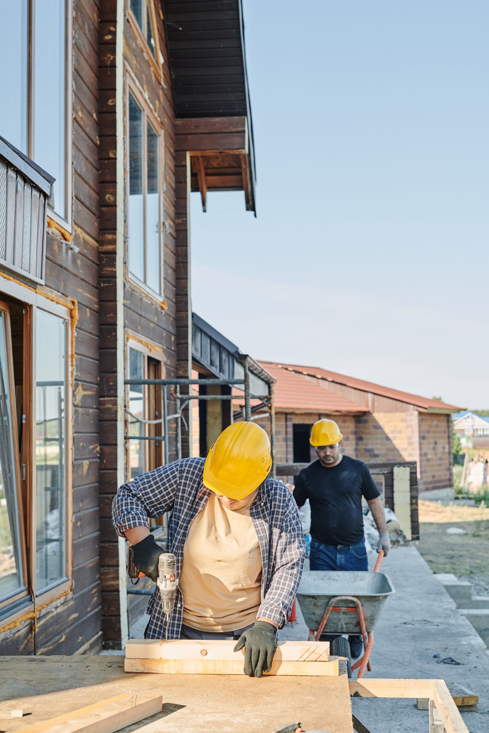 Workers in hard hats collaborating at an active construction site