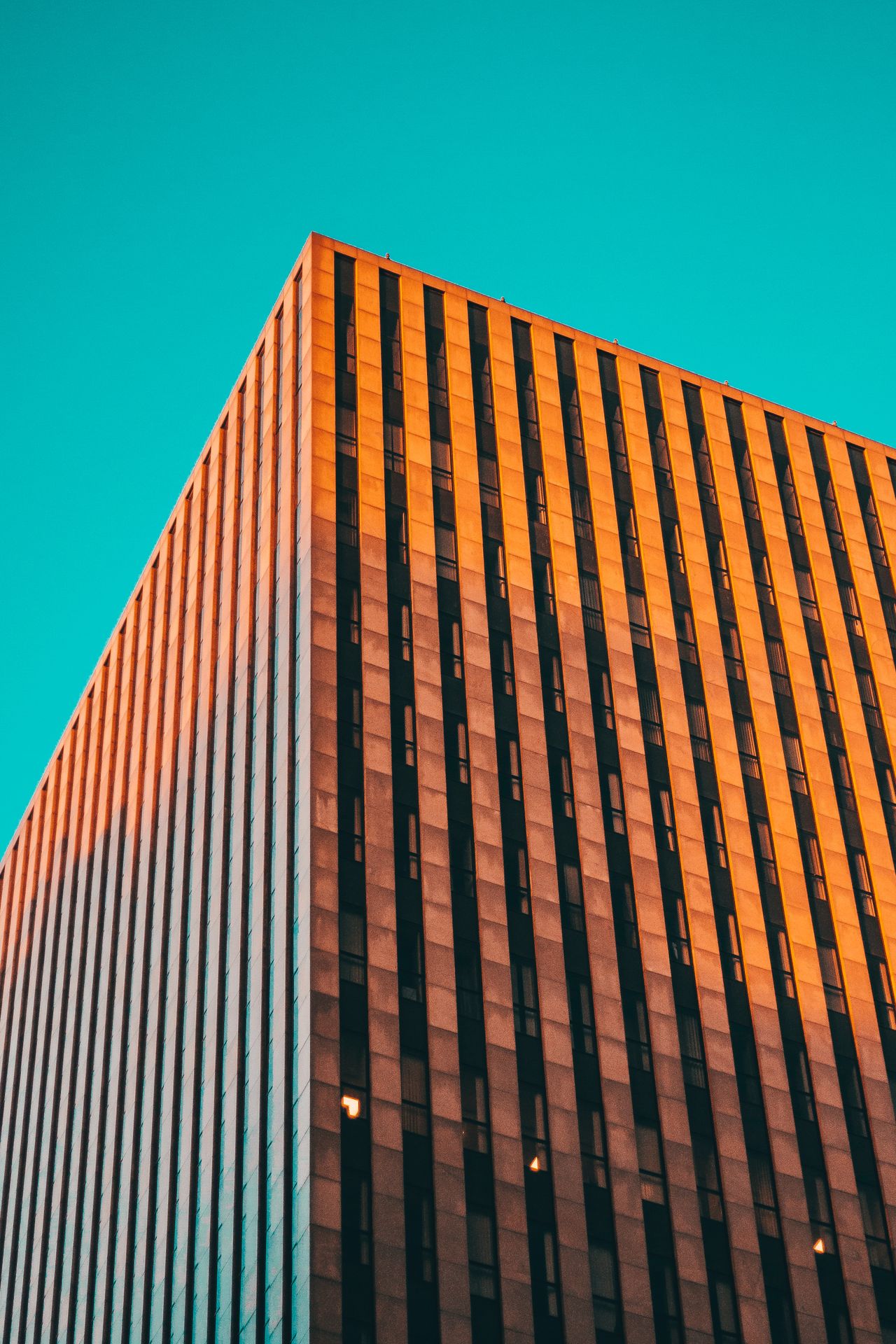 Exterior of a modern geometric building with angular lines lit by sunset light